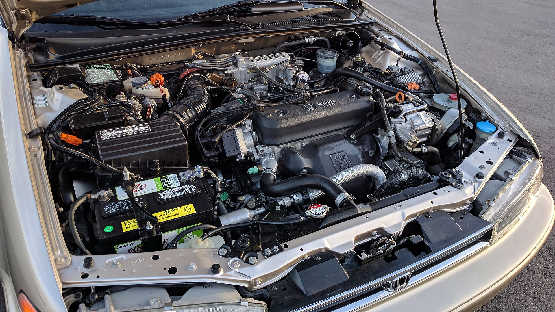 An open car engine bay showing the engine and surrounding components