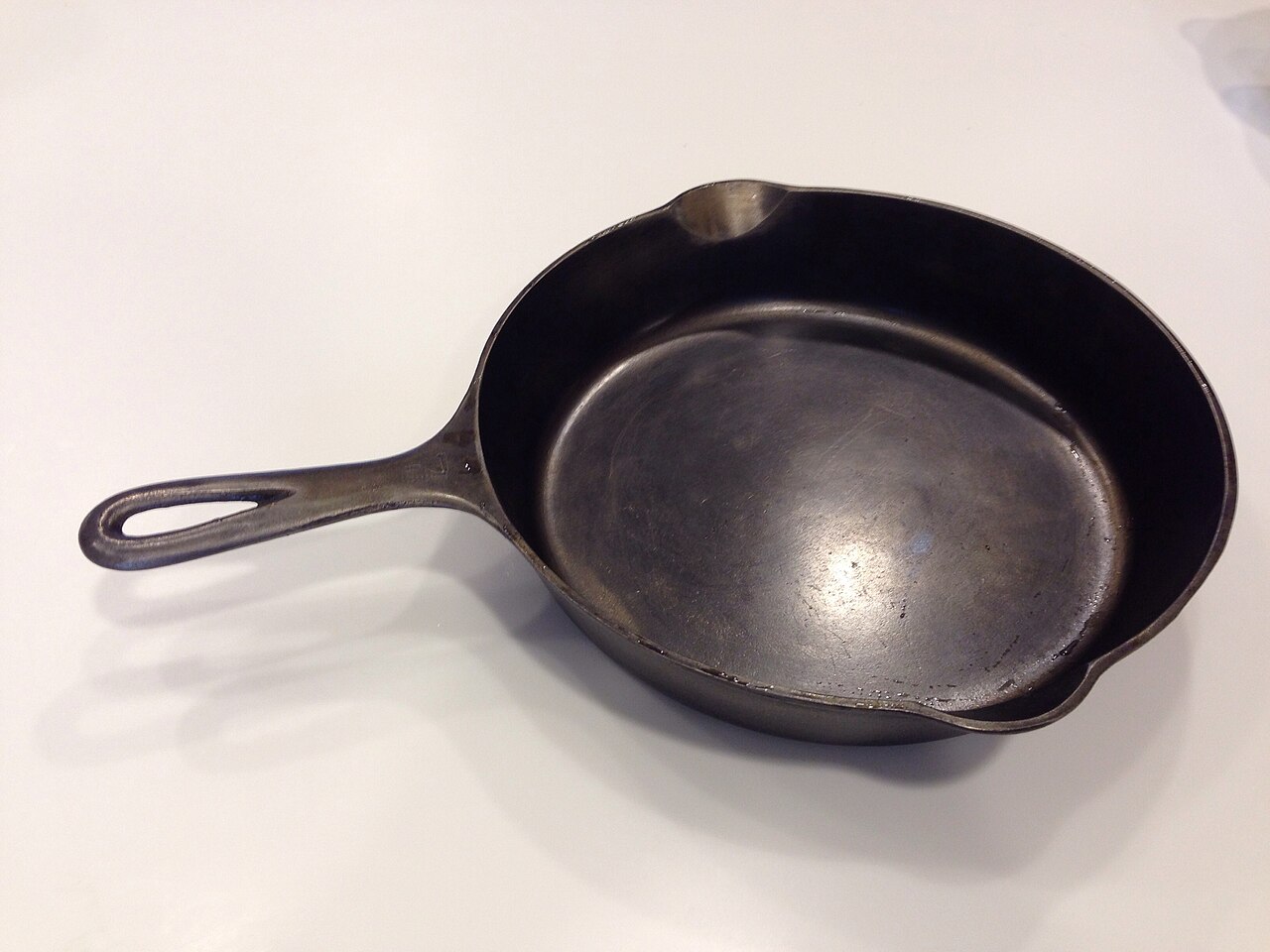 A seasoned cast iron skillet with its classic black patina