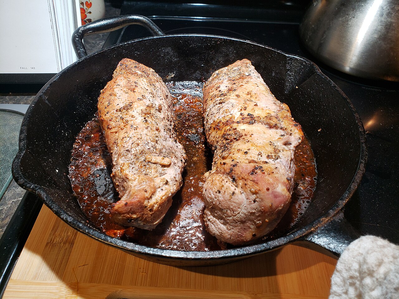 Pork tenderloin seared in a cast iron skillet