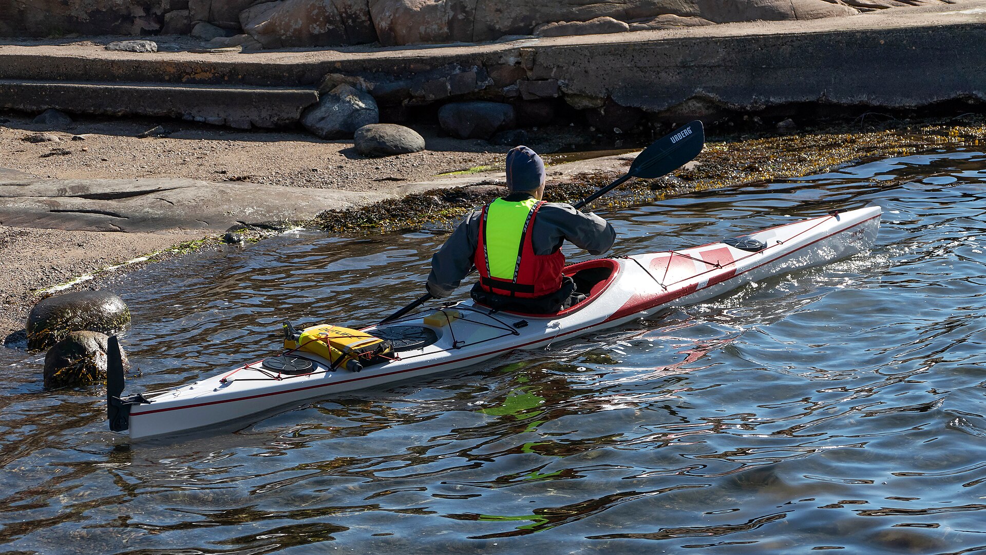 A kayaker in a sit-inside kayak on open water