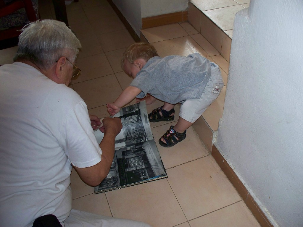 An adult and a toddler sharing a quiet moment with a book