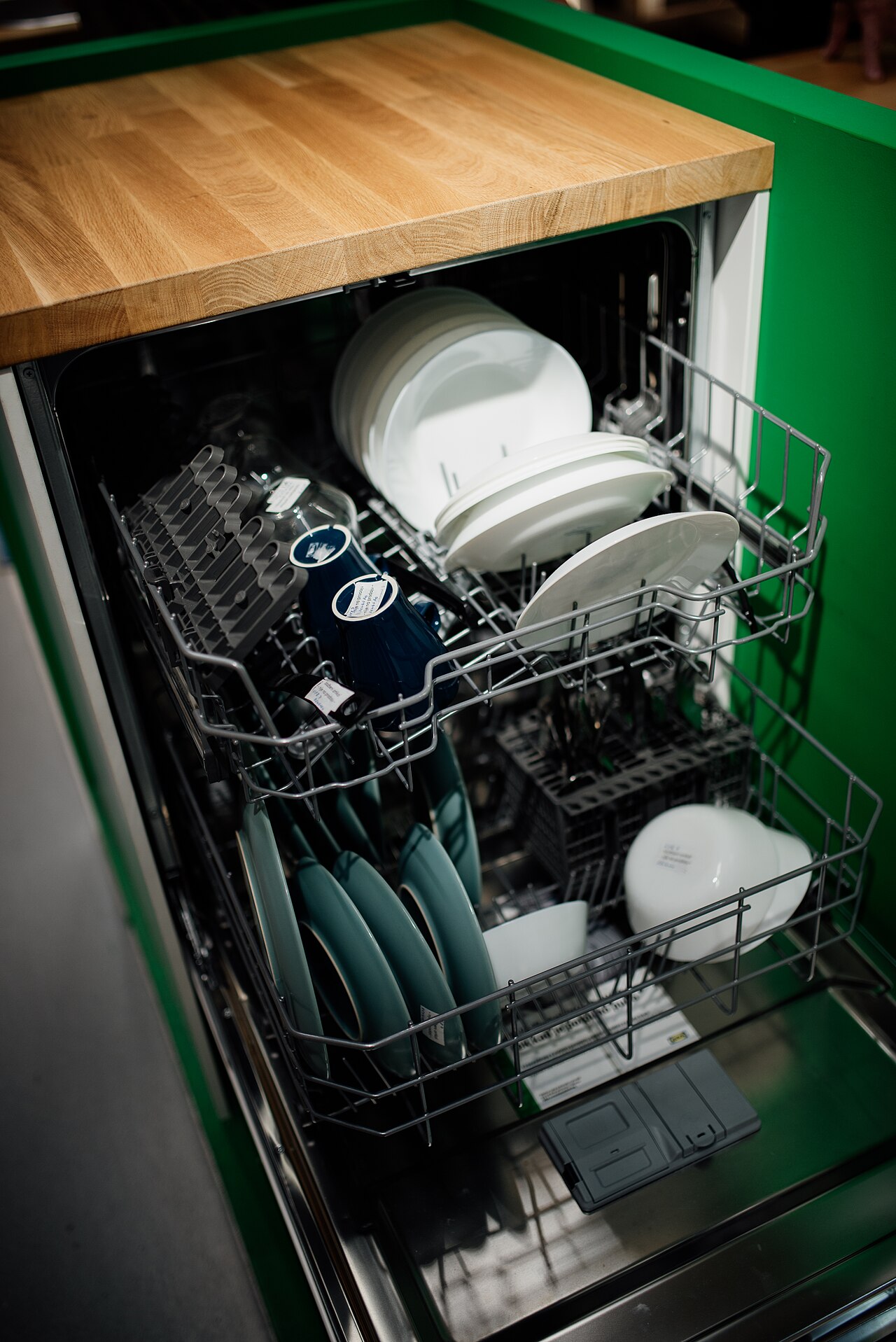A dishwasher loaded with dishes, ready for a wash cycle