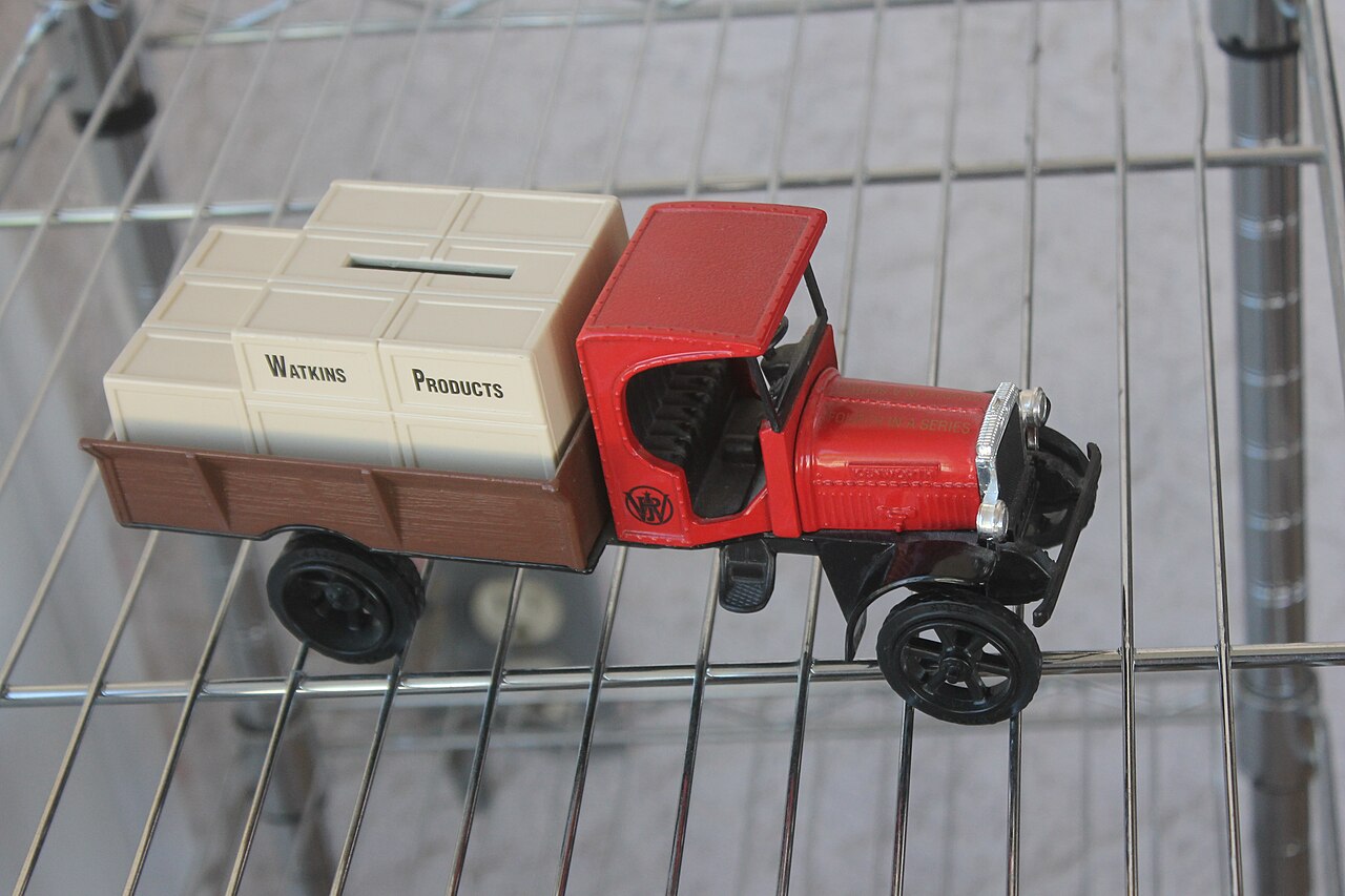 A truck-shaped collectible piggy bank on a shelf