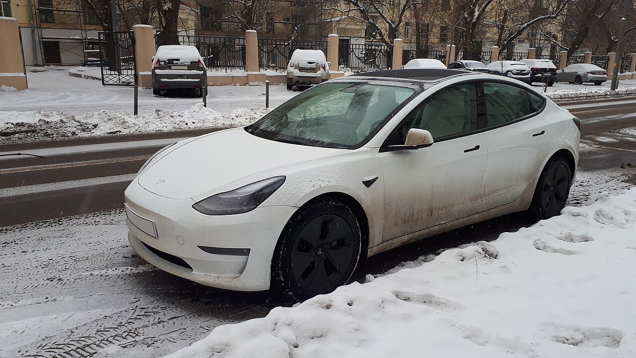 A Tesla Model S covered in snow in winter conditions