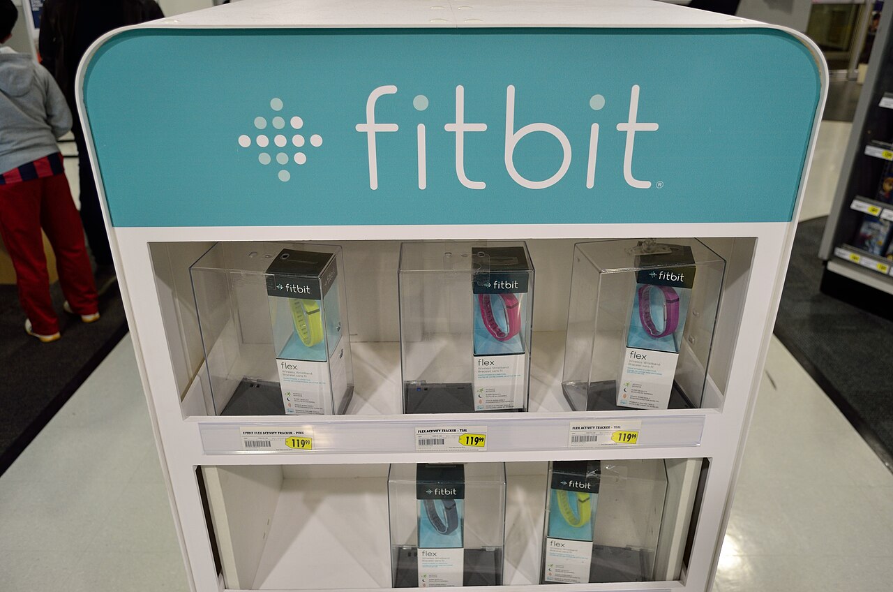 A display stand of Fitbit activity trackers in a store