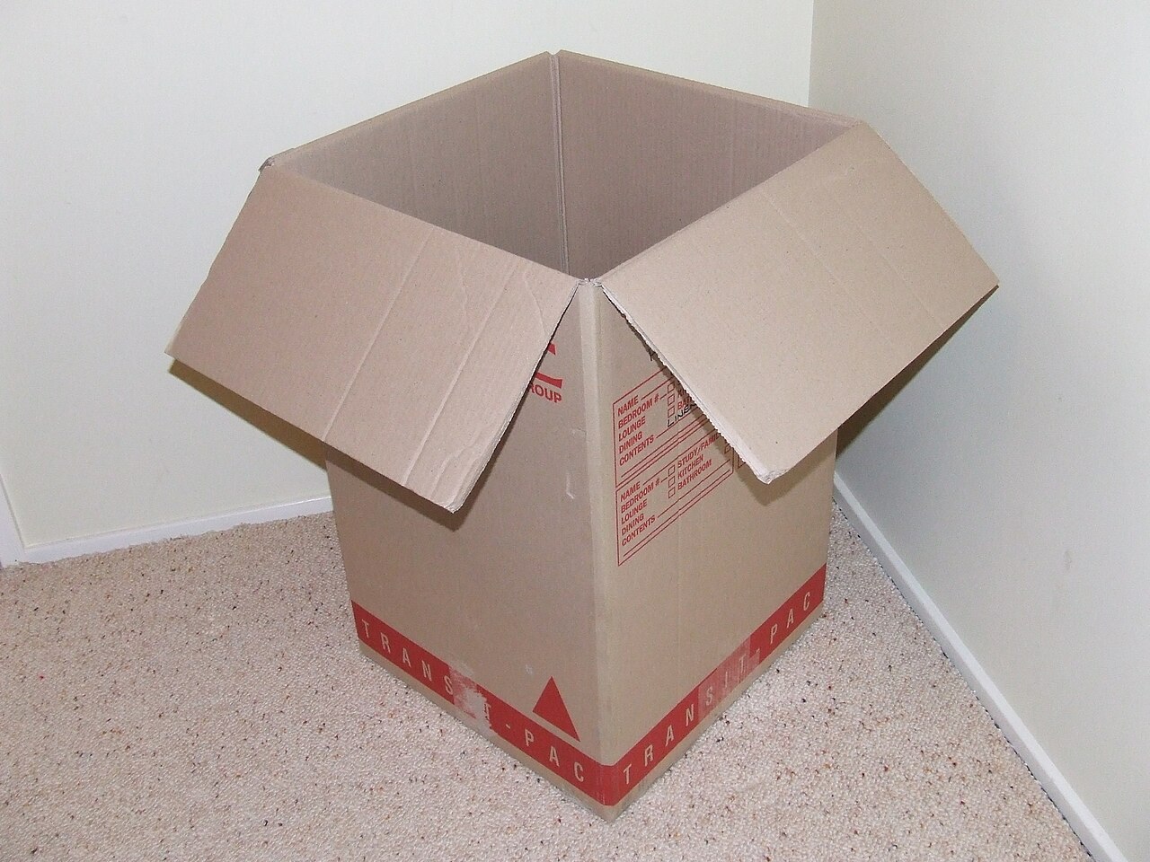 A cardboard moving box photographed in close detail, a visual for the transition of changing jobs and deciding what moves with you