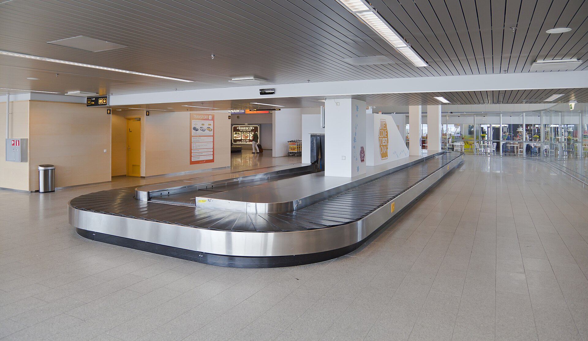 An empty baggage carousel in an airport arrivals hall