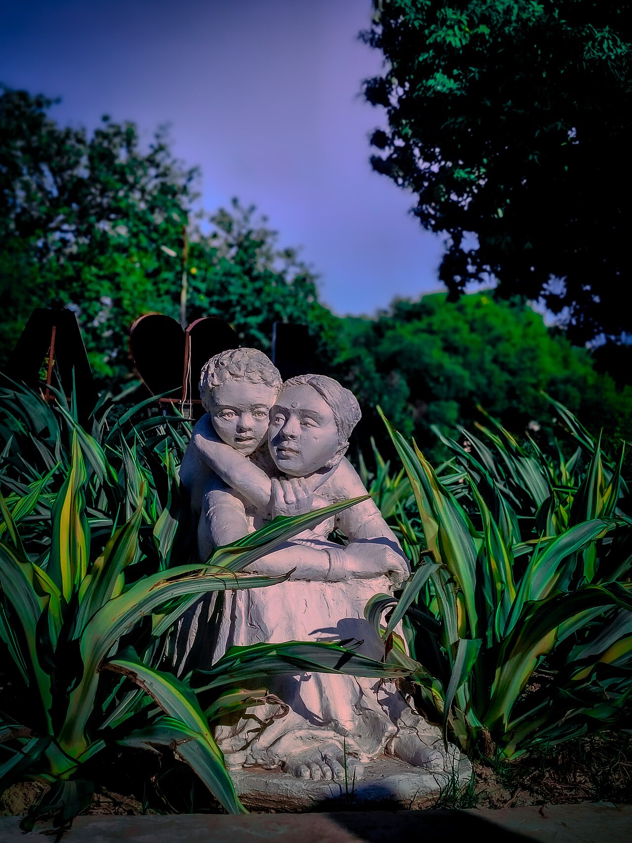 A sculpture of a mother and child embracing