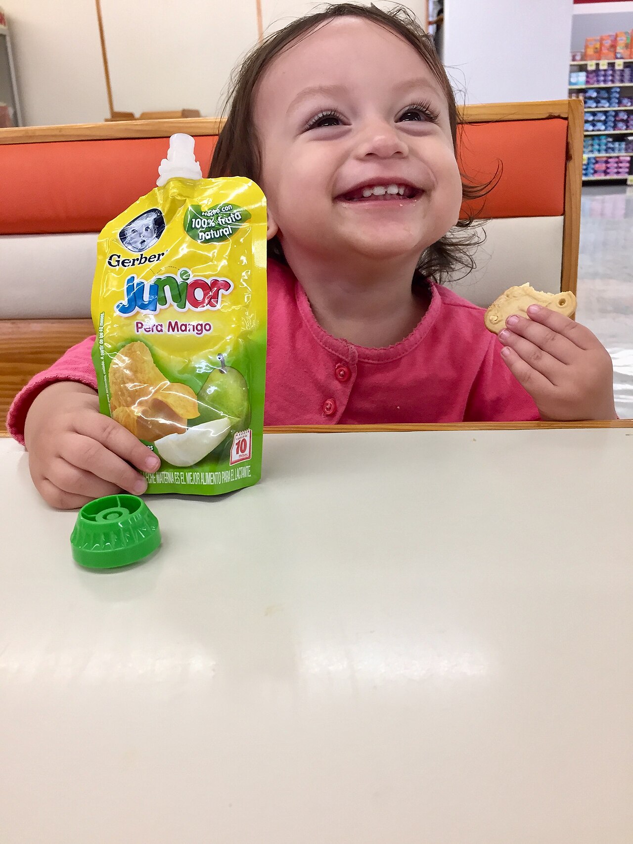 Smiling toddler holding a cookie