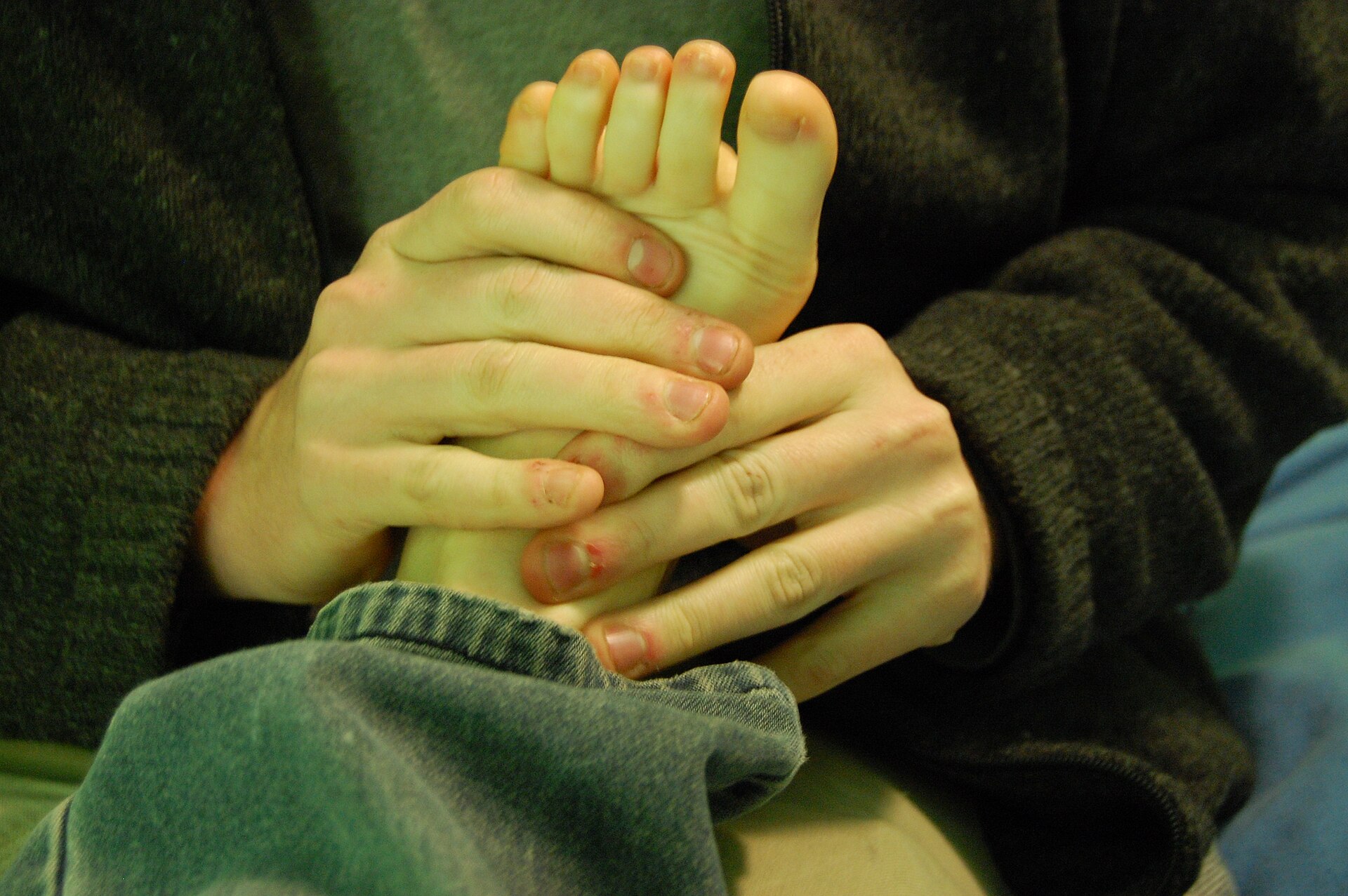 Hands cracking toe knuckles
