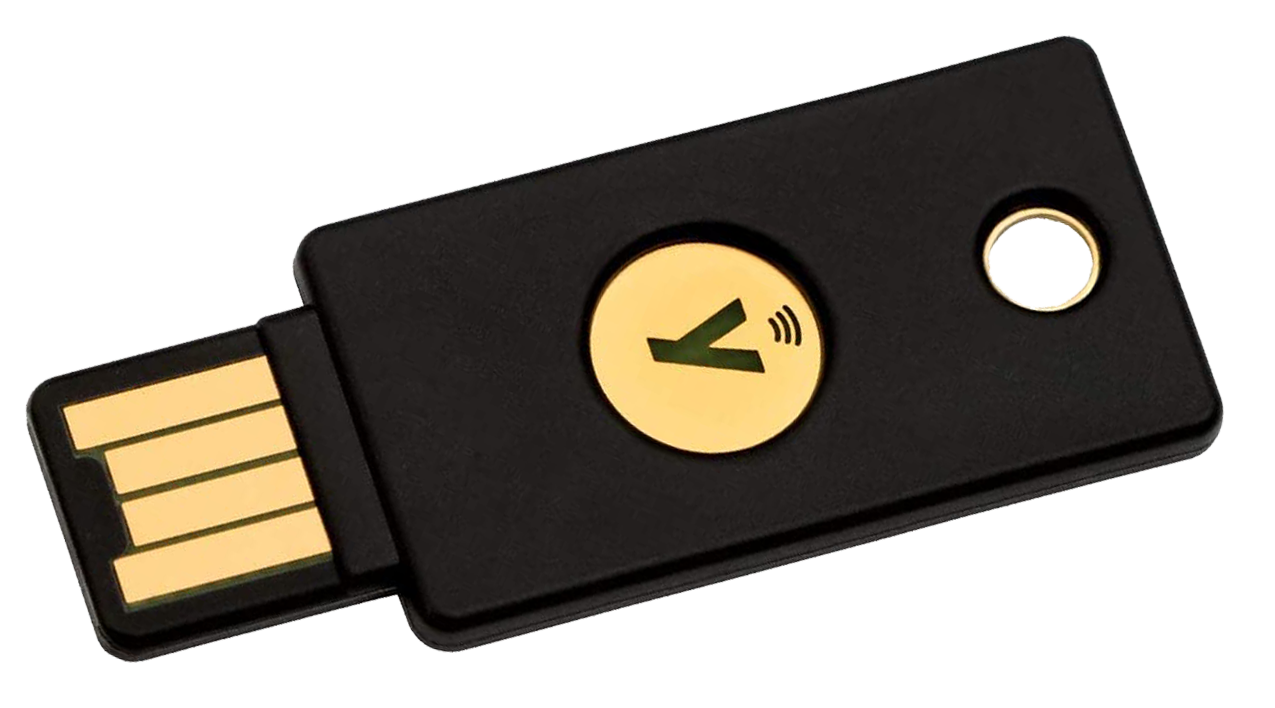 A FIDO2 USB security token next to a phone, showing the hardware-key side of passkey authentication