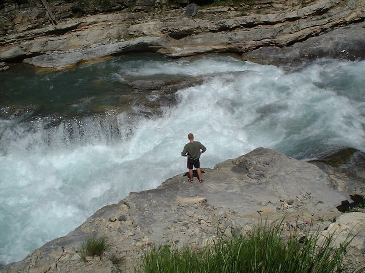 Whitewater rushing over a triple-step drop on the River Guil in the French Alps