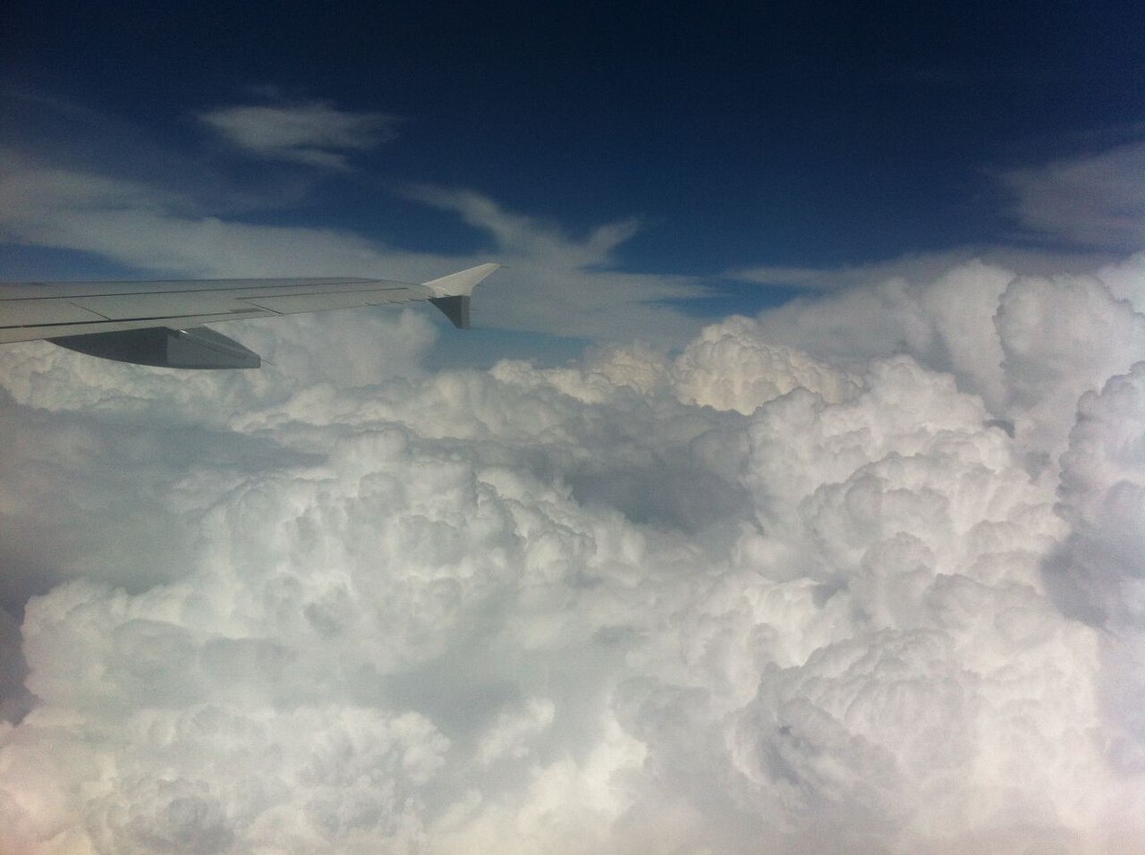 Cumulus clouds seen from above through an airplane window