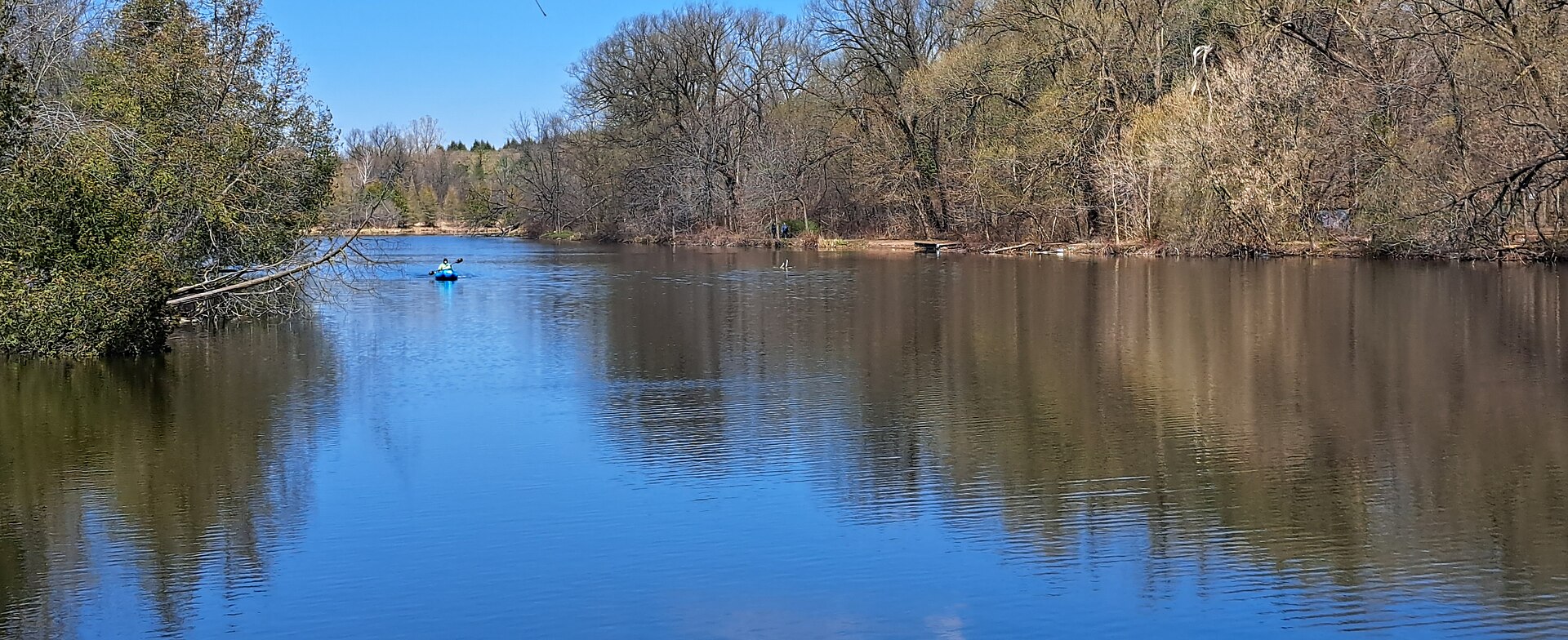 A kayaker paddling on a river