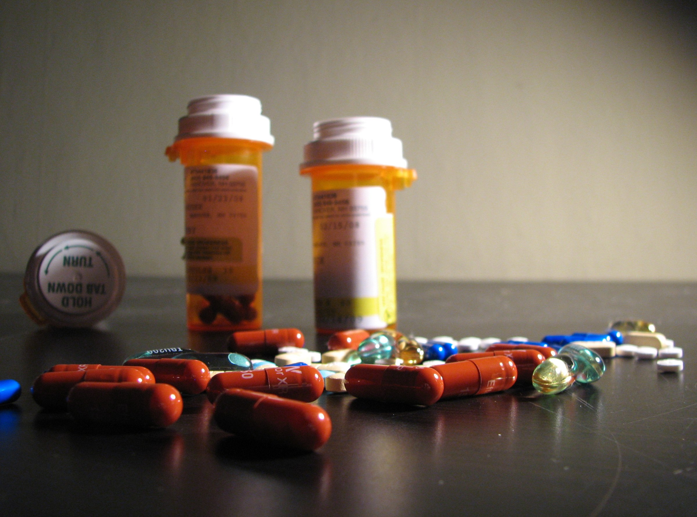 Assorted medicine bottles and loose pills
