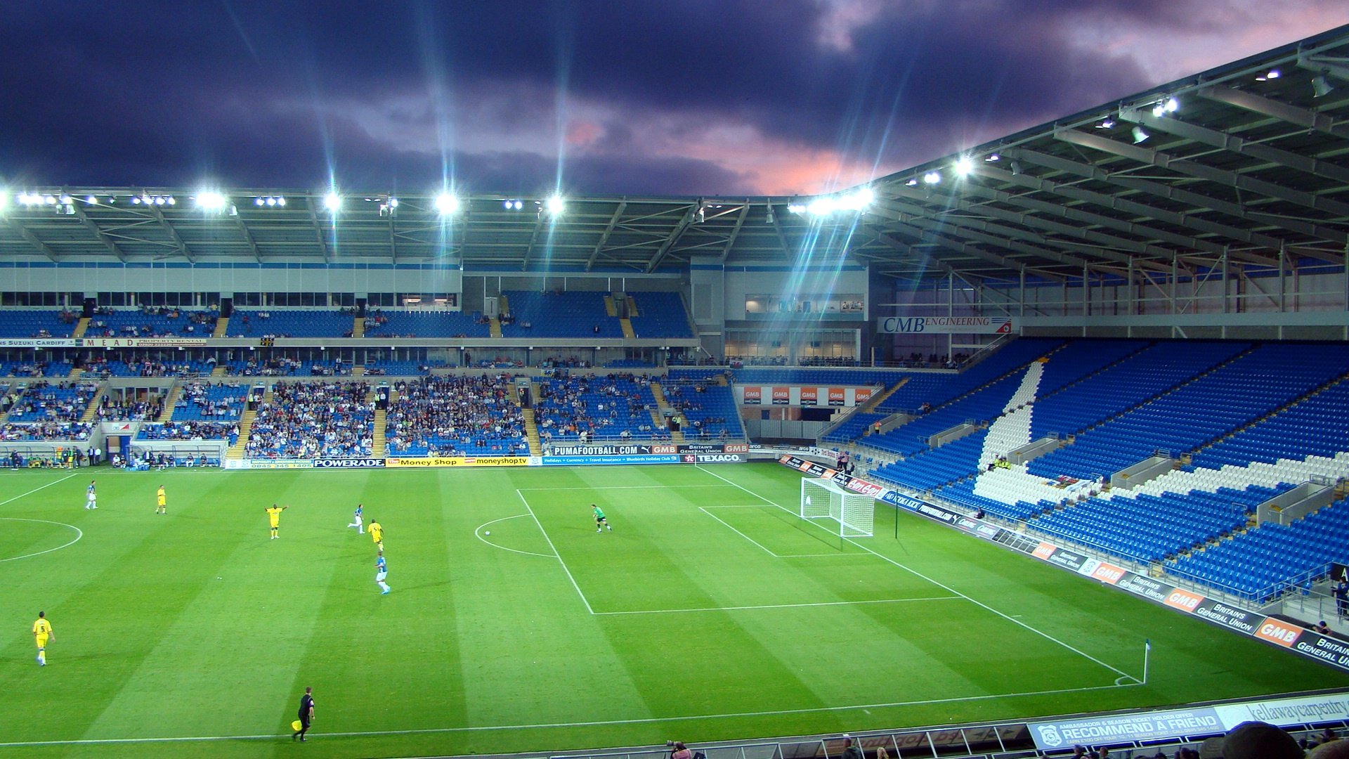 A football stadium under lights at night