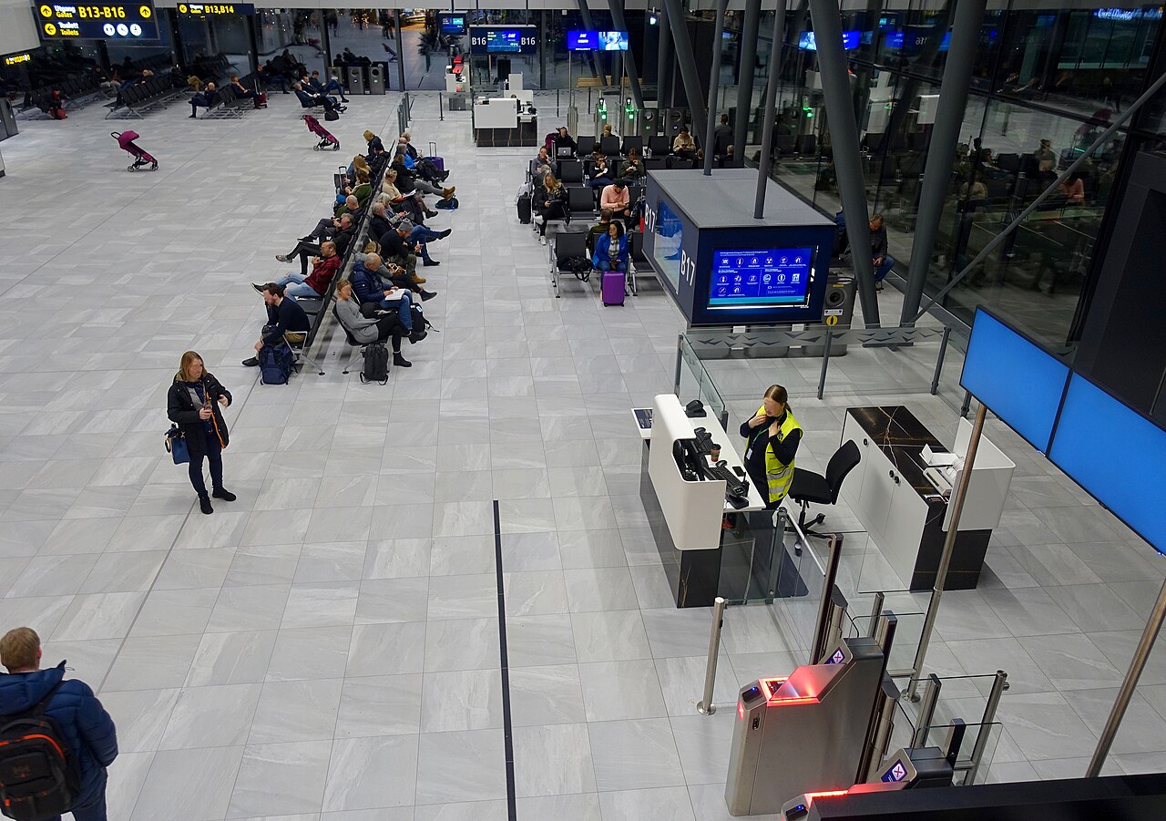 Passengers waiting in a departure gate seating area