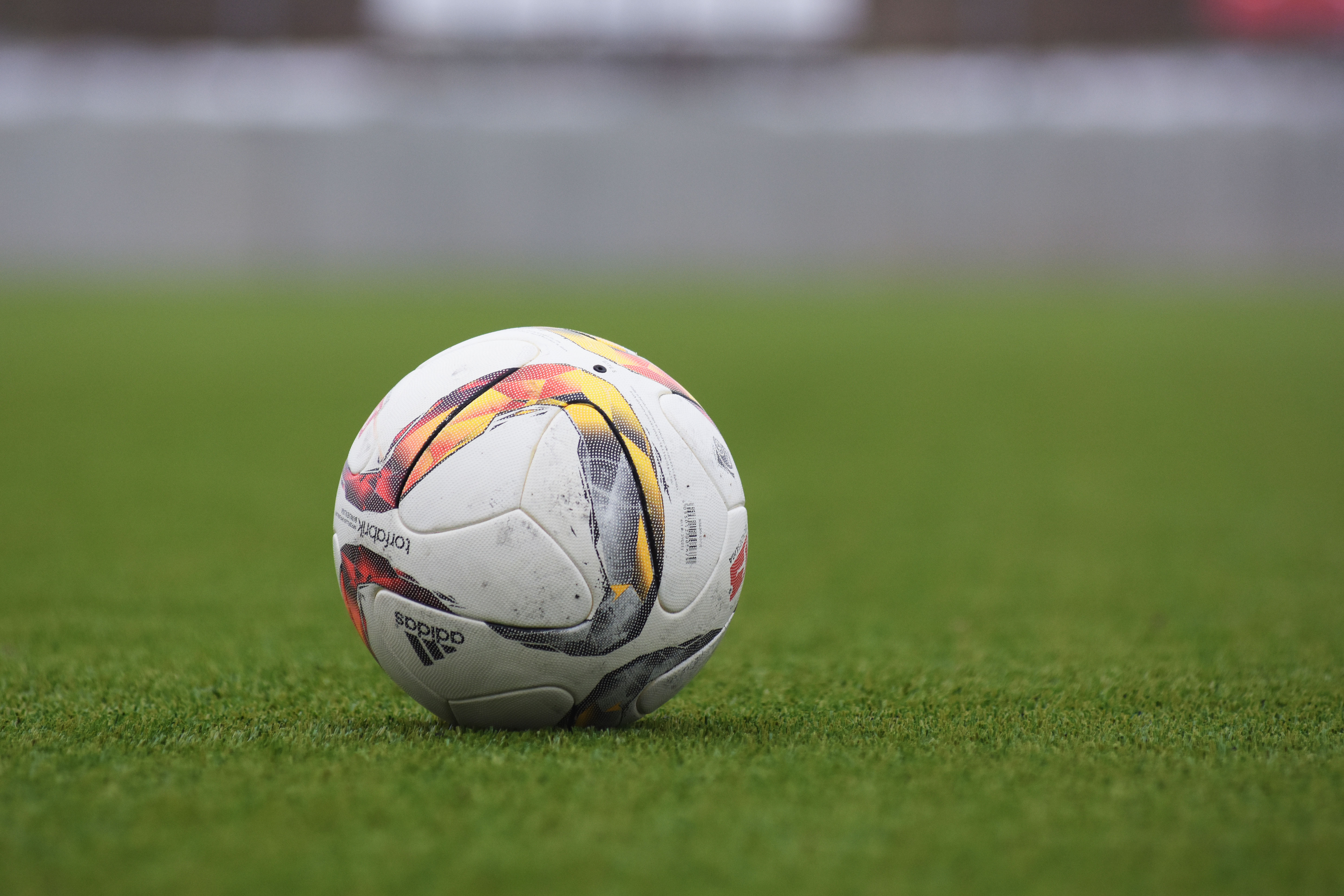 A football resting on green grass