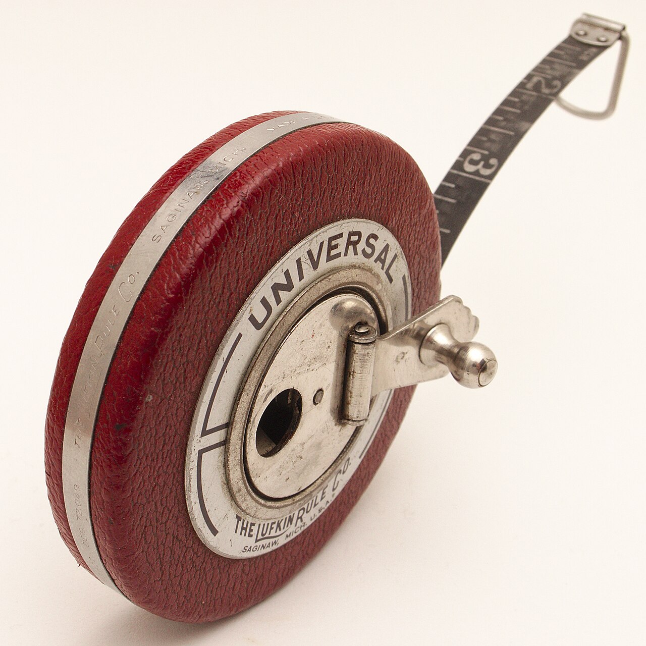 A tape measure extended on a wooden surface