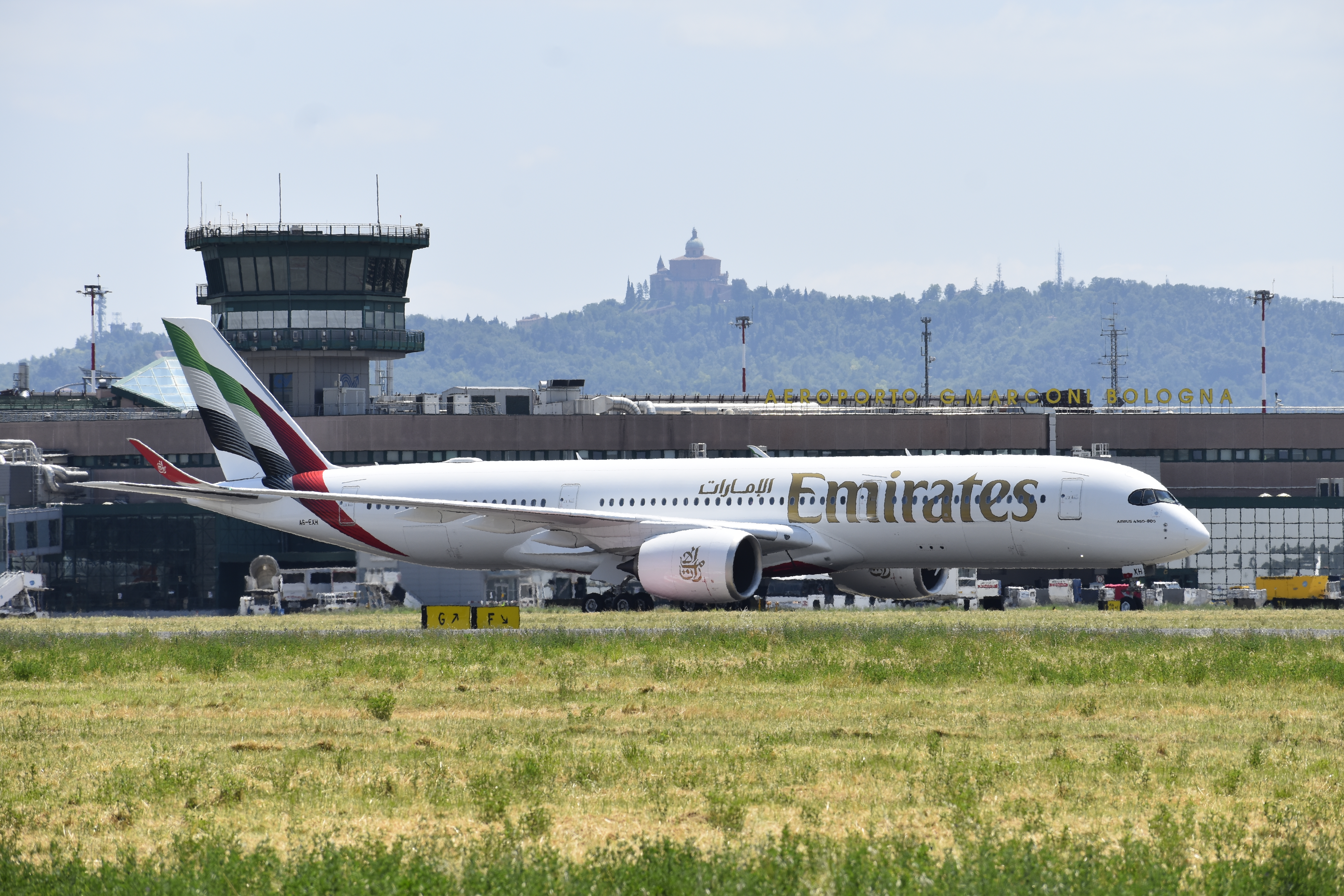 An Emirates Airbus A350-900 passenger jet on the ground at an airport