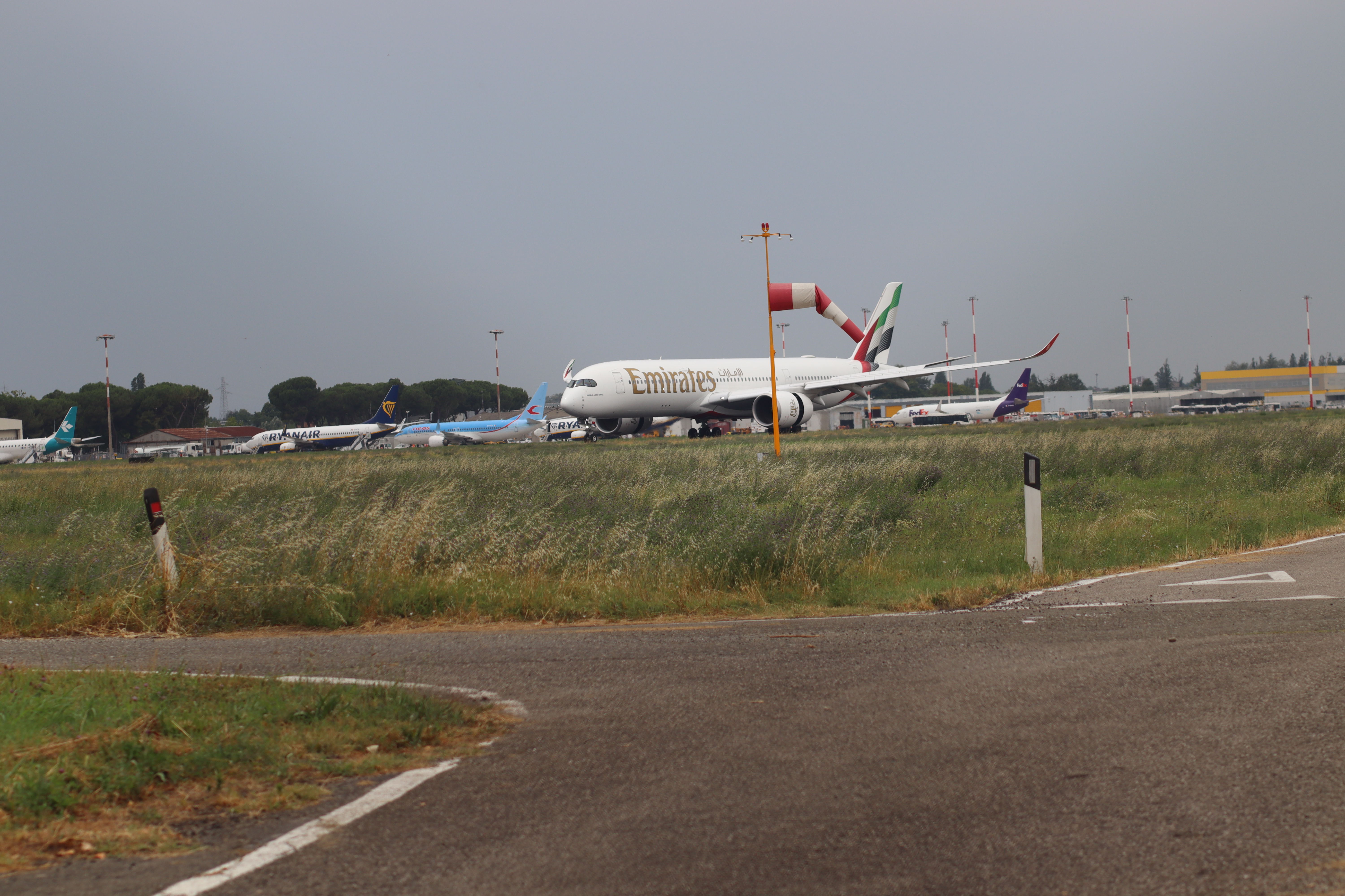 An Emirates wide-body passenger jet taxiing at an airport in 2025