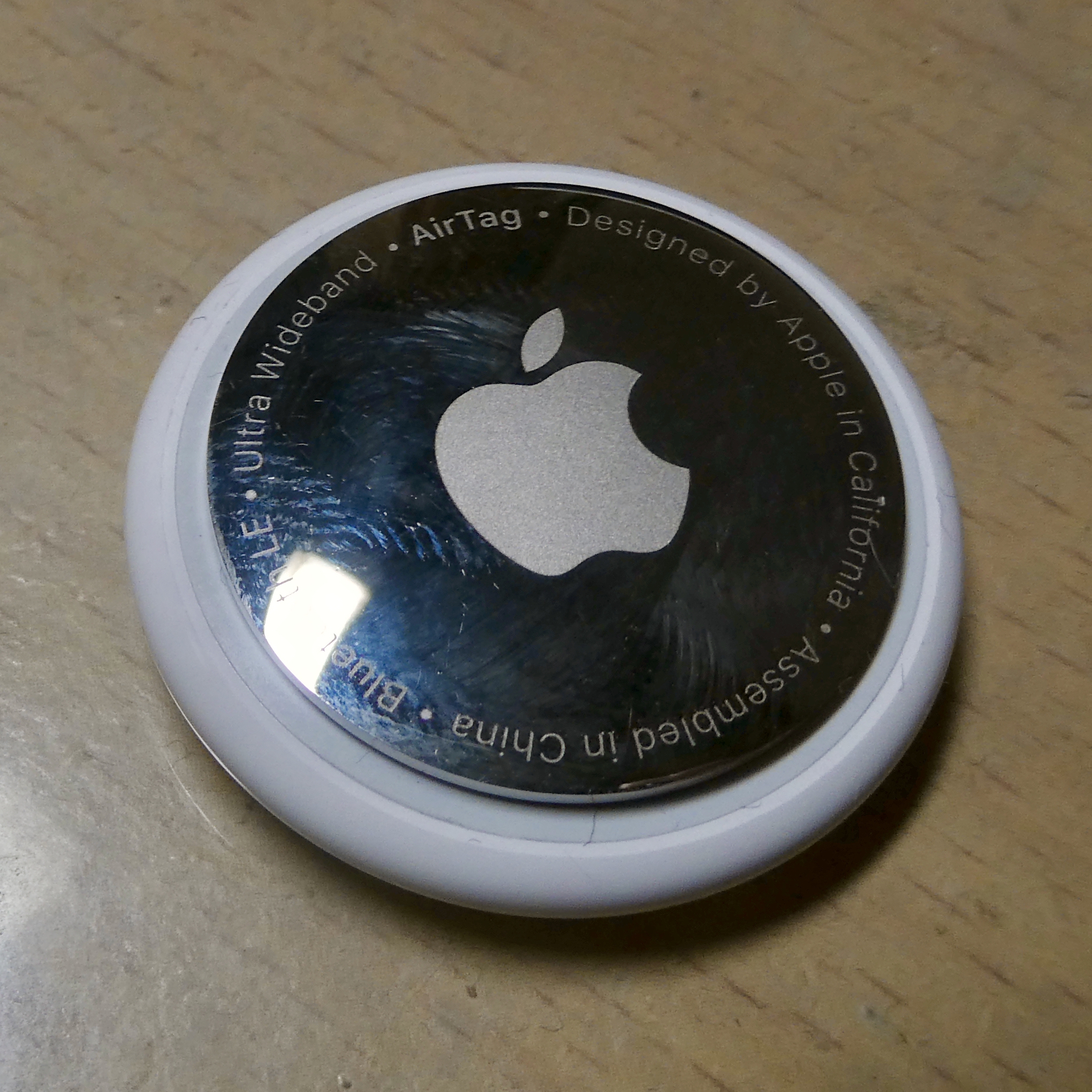 An Apple AirTag, the coin-sized Bluetooth tracker that rides on the Find My network