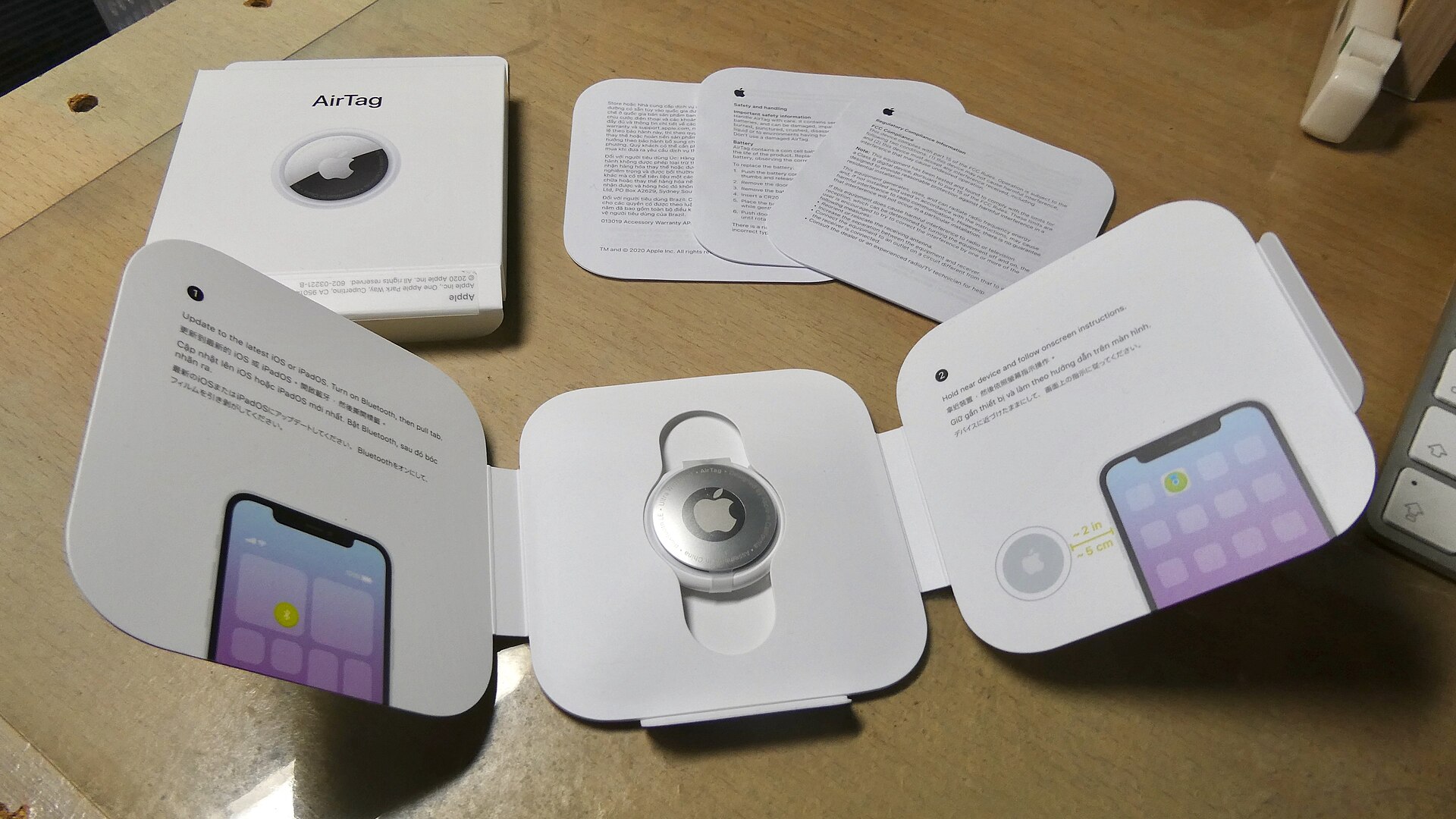 A second view of an Apple AirTag, the Bluetooth tracker for the Find My network