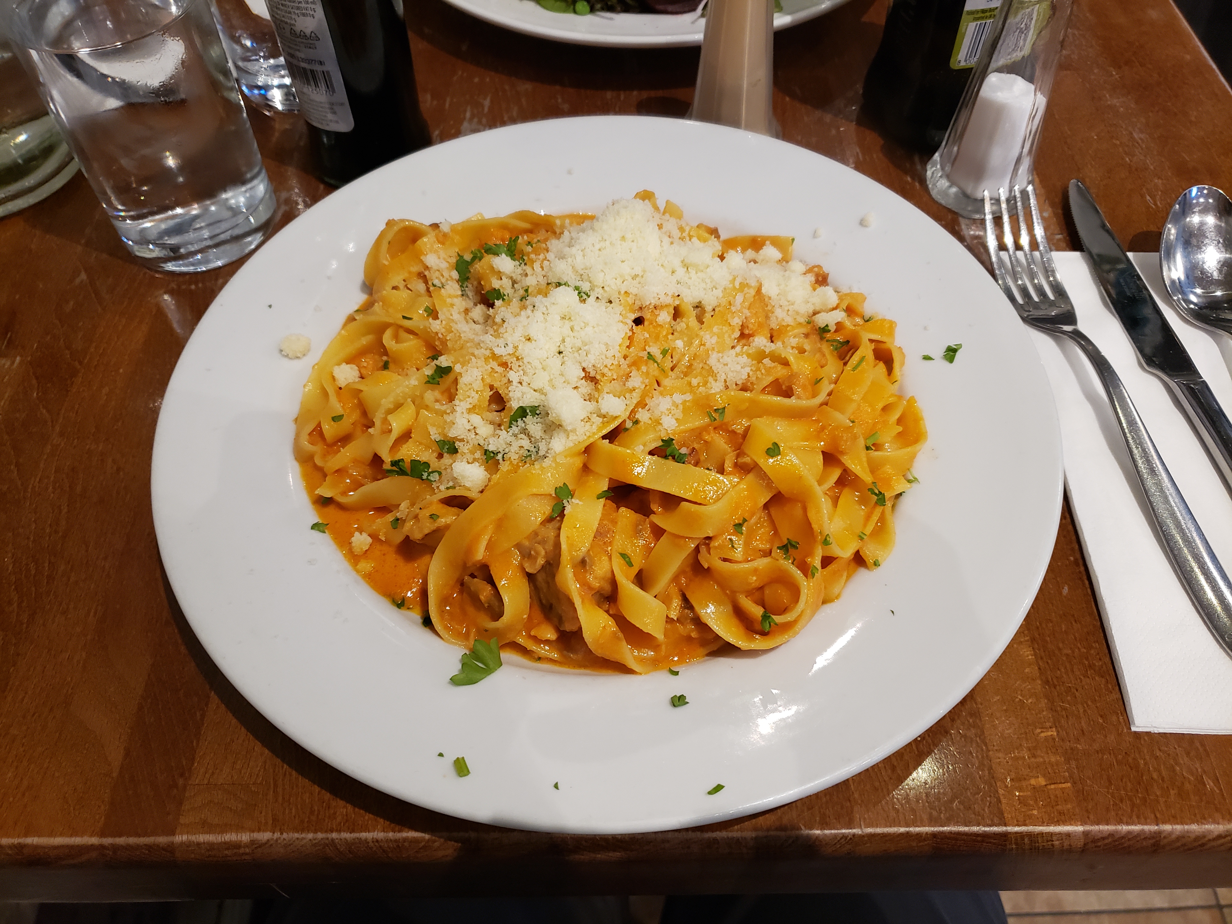 Fresh tagliatelle with salmon served at a restaurant