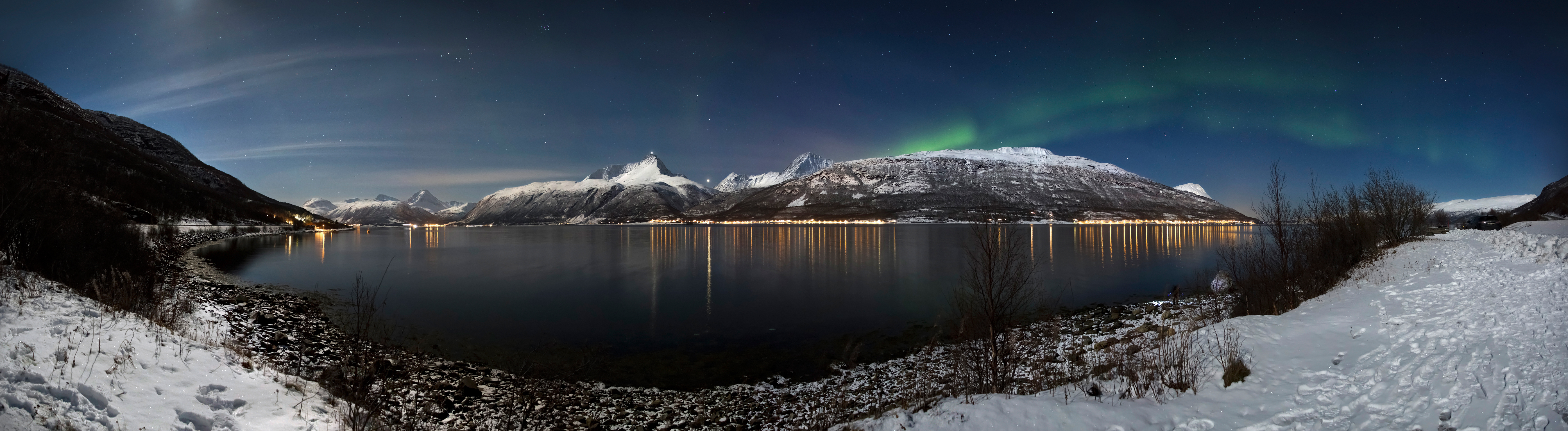Aurora curtains over the Lyngen Alps in moonlight