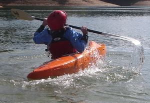 A kayaker completing the finish position of the C-to-C roll