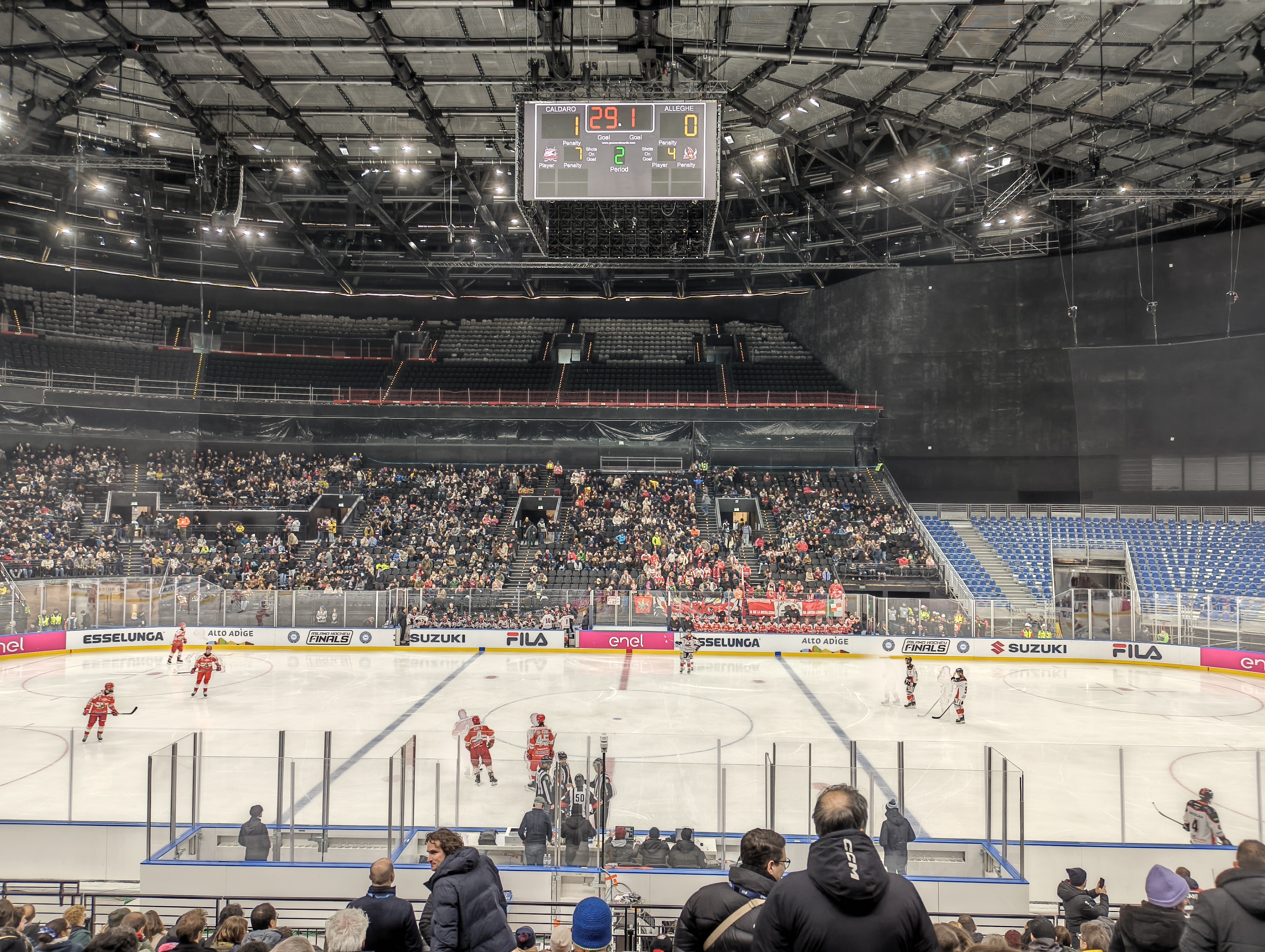 An ice hockey arena with the rink lit up before faceoff