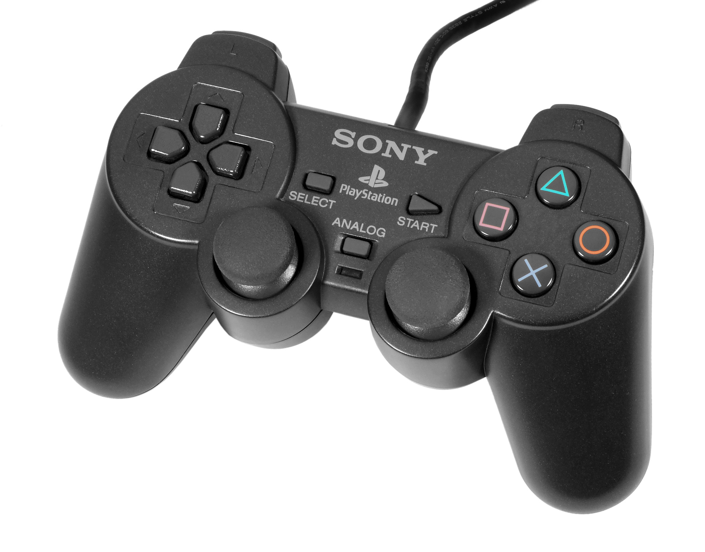 A video game controller resting on a dark surface