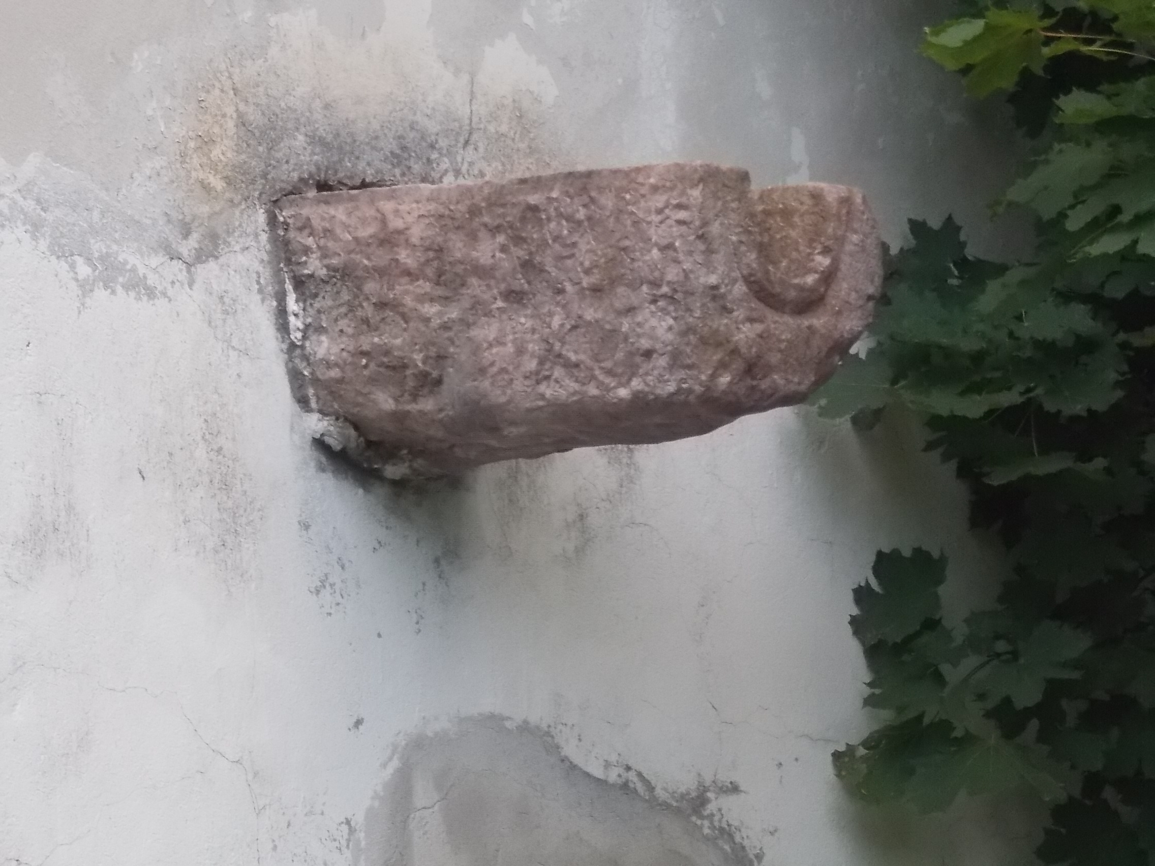 A rain gutter running along the eaves of an old building