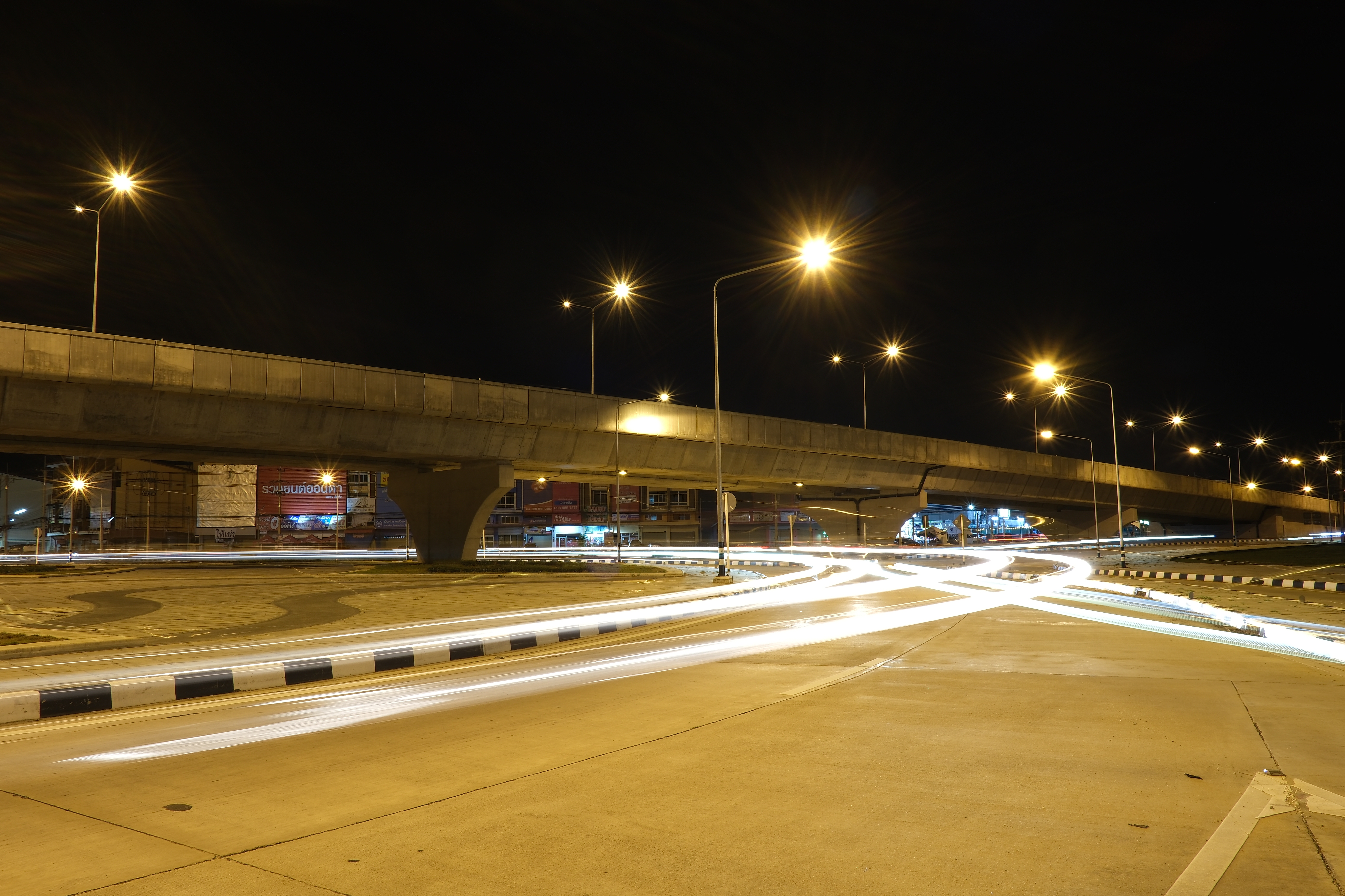 Nighttime long-exposure of car headlights on an urban road
