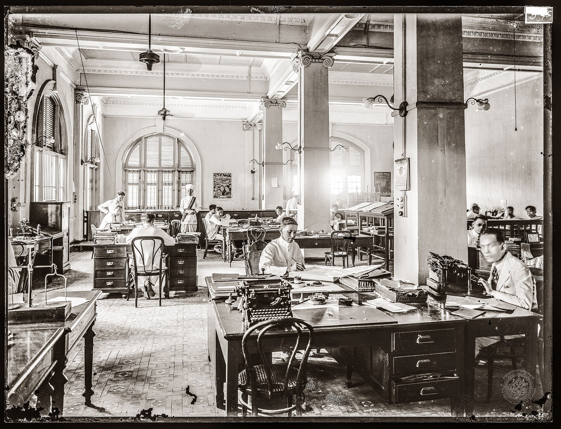 A large open-plan office with rows of desks, typical of a busy workplace