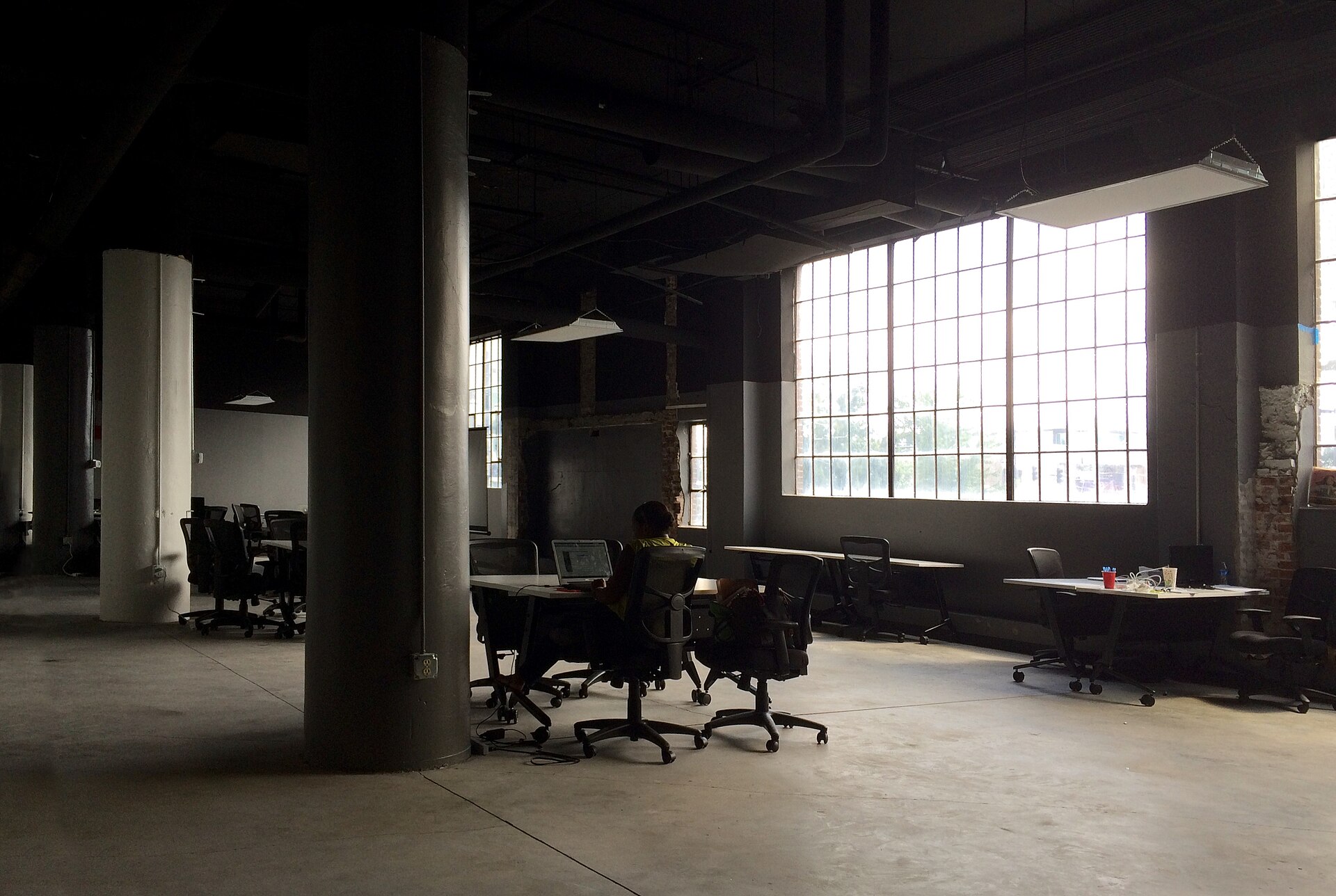 A lone office worker at a desk, focused on the screen