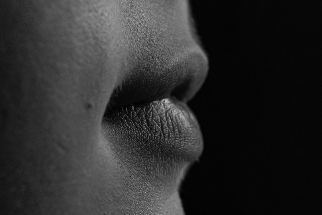 Black-and-white close-up of lips showing skin texture and fine details