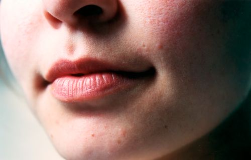 Close-up of a woman's lips with natural skin texture