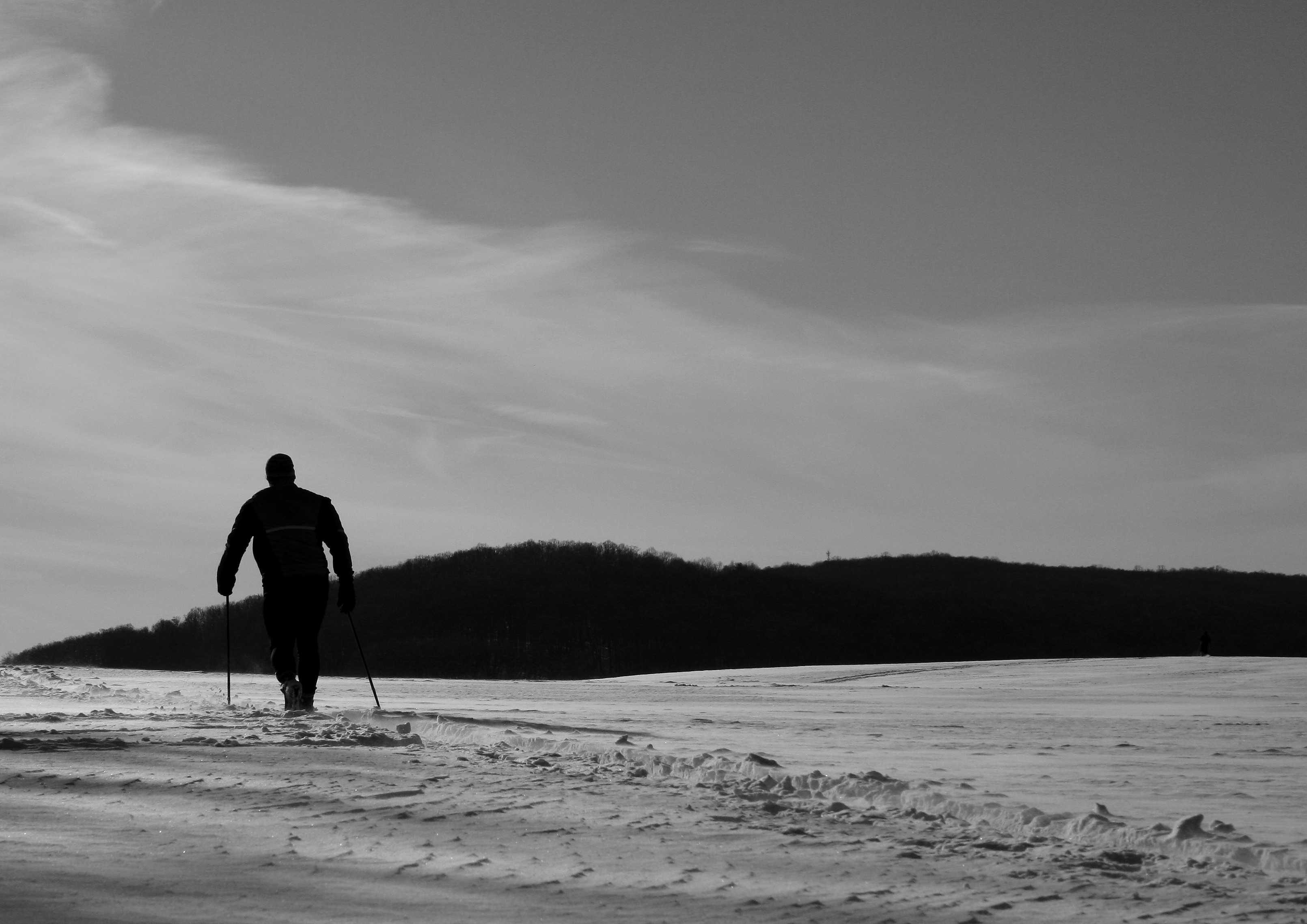 A cross-country skier training in a snowy winter landscape