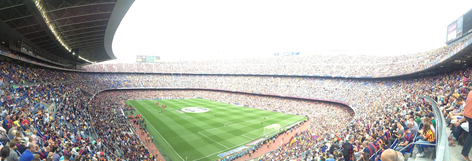 A packed football stadium under lights