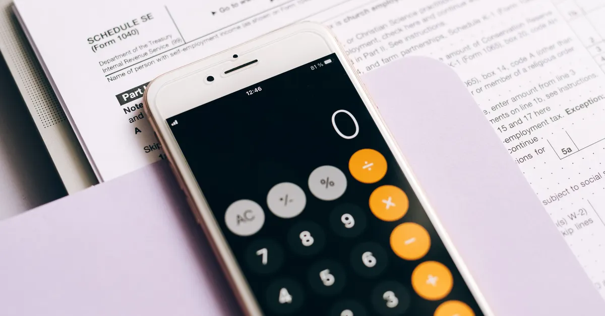 A mobile phone with a calculator app on a table