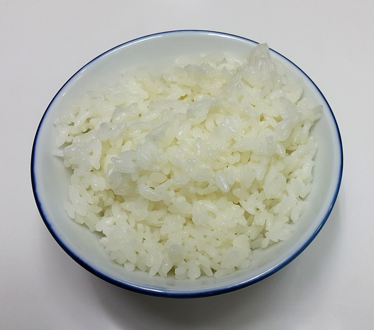 A bowl of fluffy cooked white rice with separate grains