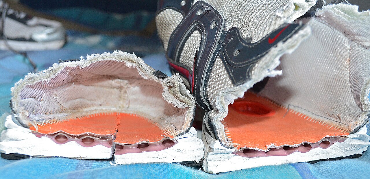 A running shoe cut in half to show its internal construction and foam layers