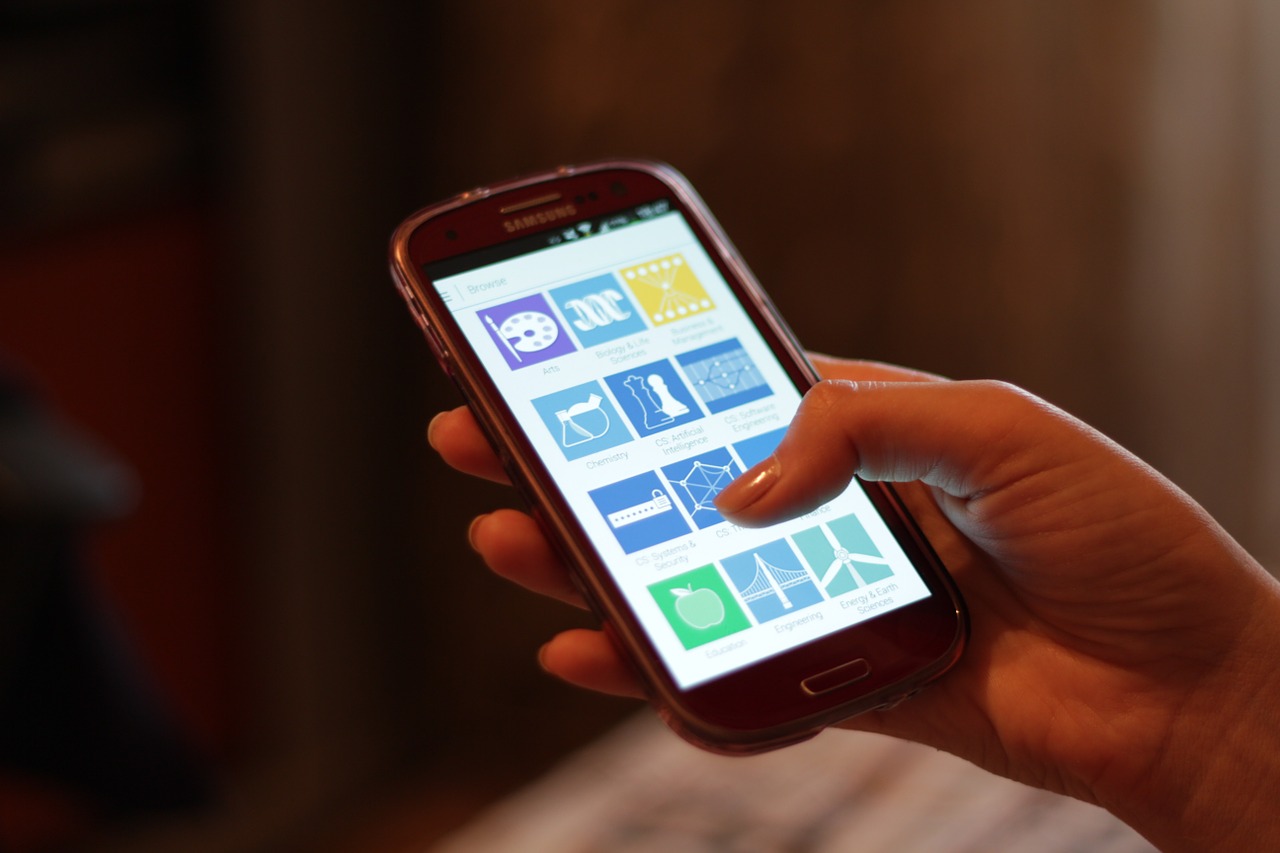People using smartphones in daily life; passkeys aim to make signing in as easy as unlocking the phone
