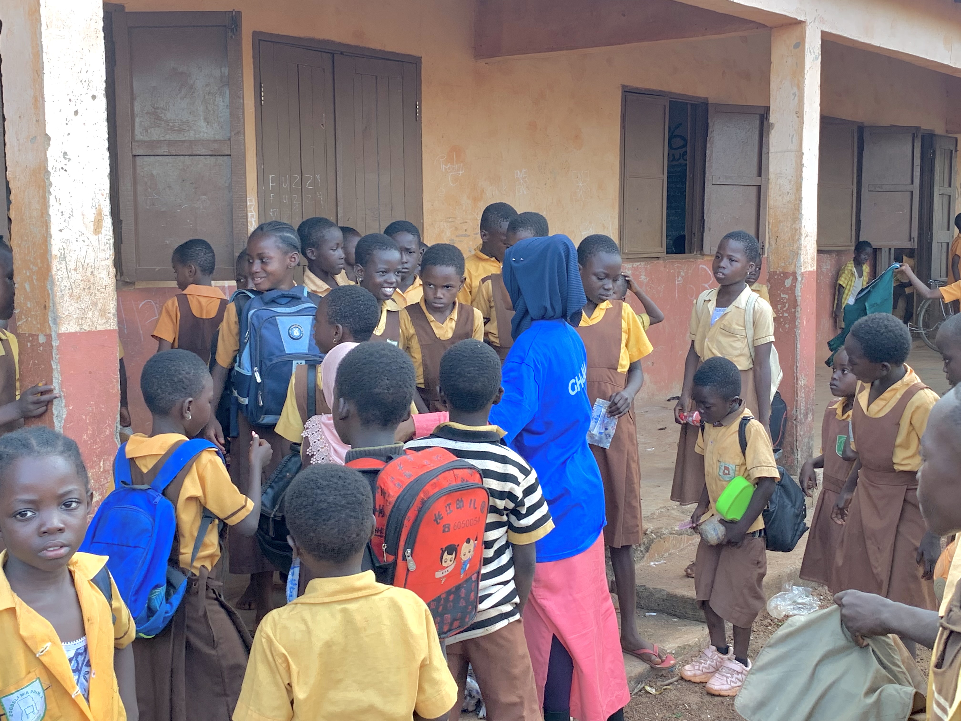 A tutor explaining material to students in a classroom