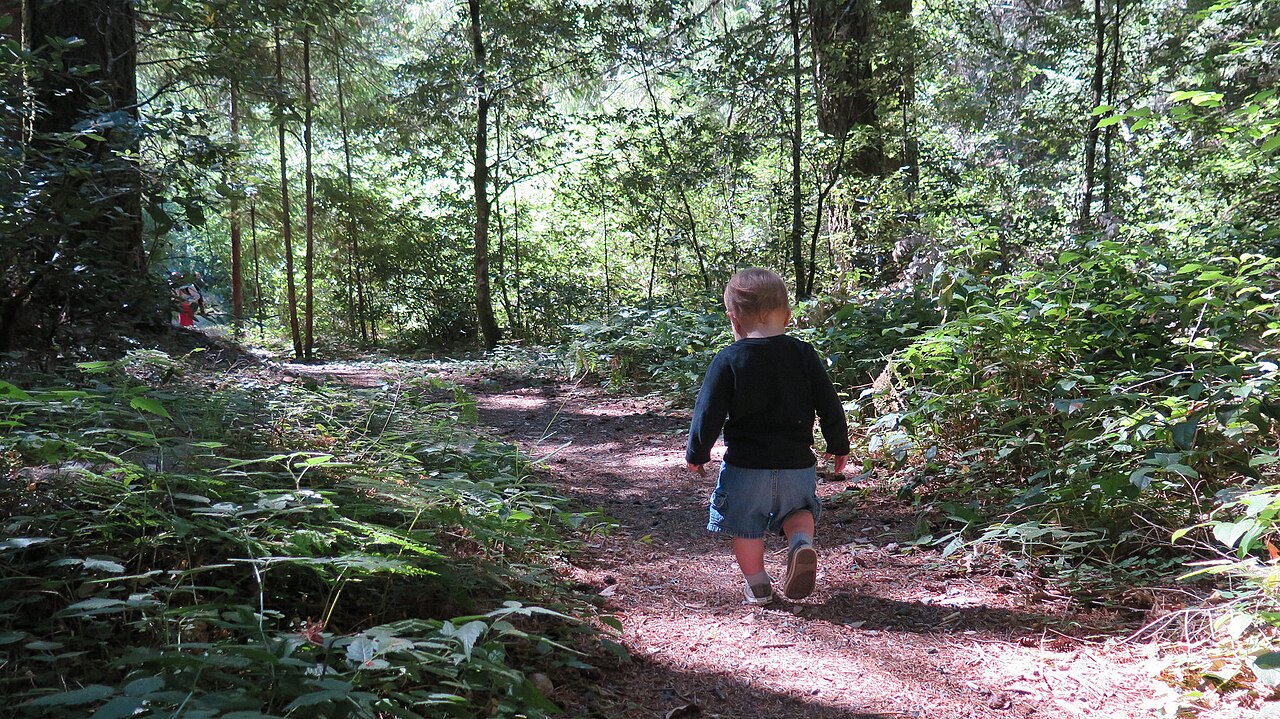 A mother holds her baby outdoors in the King Range National Conservation Area