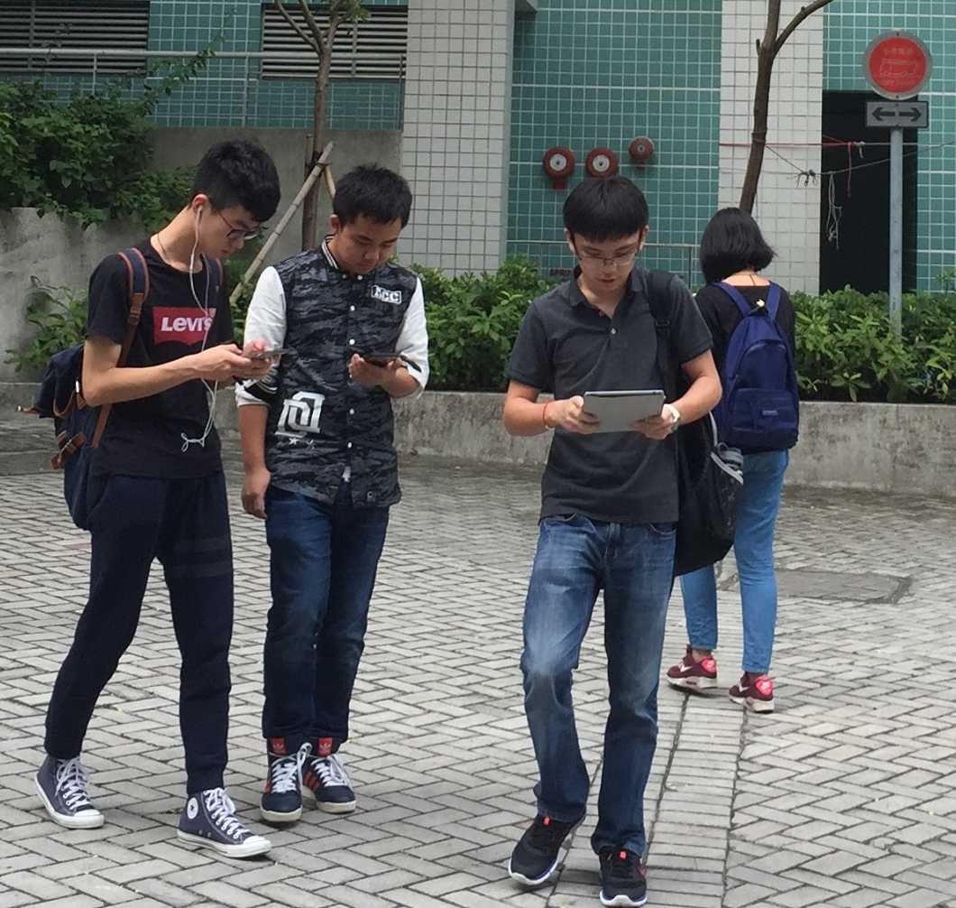 Young people using smartphones while walking