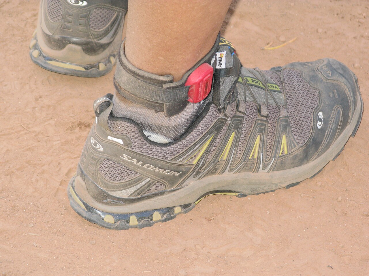 A trail running shoe photographed to show its aggressive lugged tread pattern