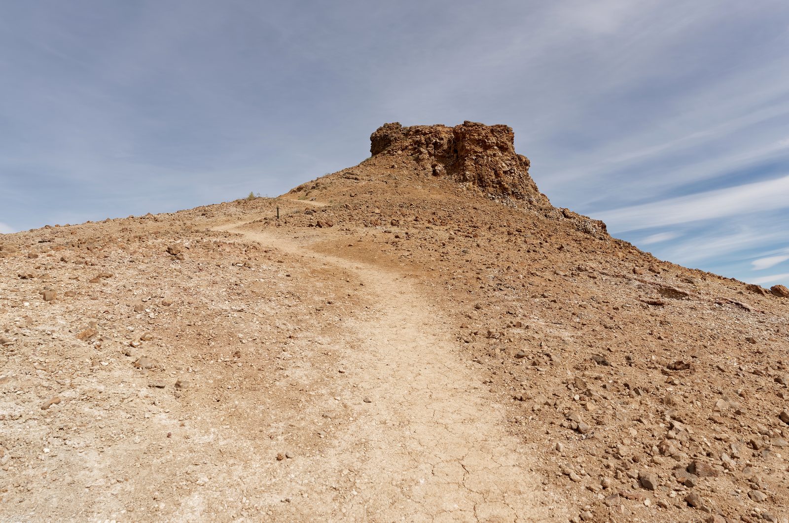 A mountain hiking trail winding up through rocky alpine terrain