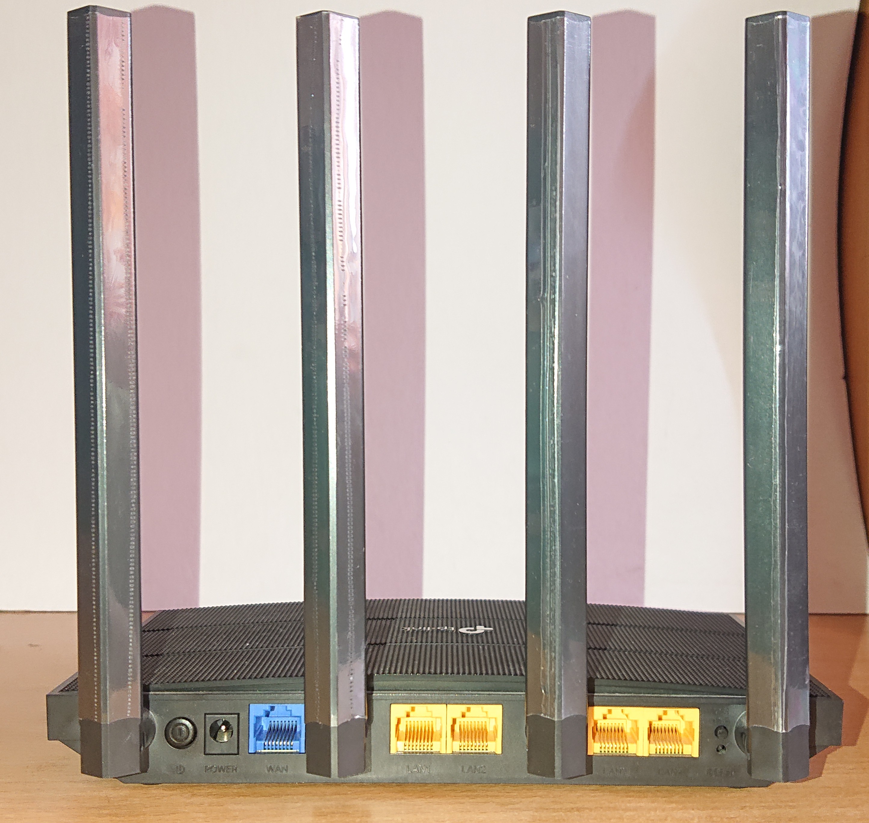 The back panel of a modern Wi-Fi router showing Ethernet ports and antennas